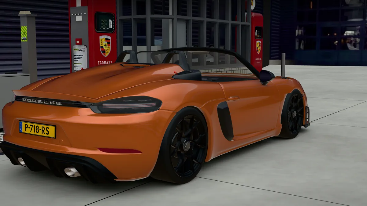 The 718 Spyder RS in Nordic Gold Metallic with black wheels, seen from the rear quarter beside a pump